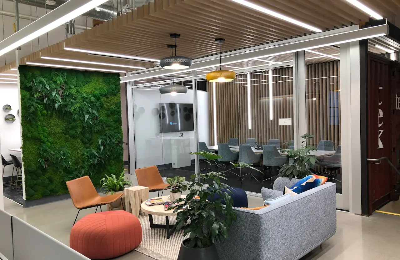 Completed office tenant improvement with a living green wall and glass conference rooms