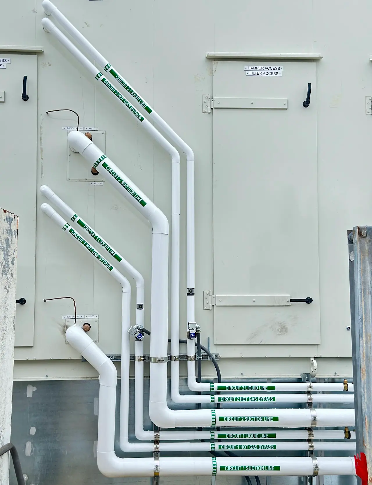 Labeled refrigerant circuit piping on commercial HVAC equipment