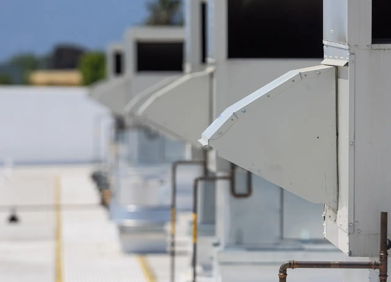 Row of rooftop exhaust hoods on a Bay Area commercial facility