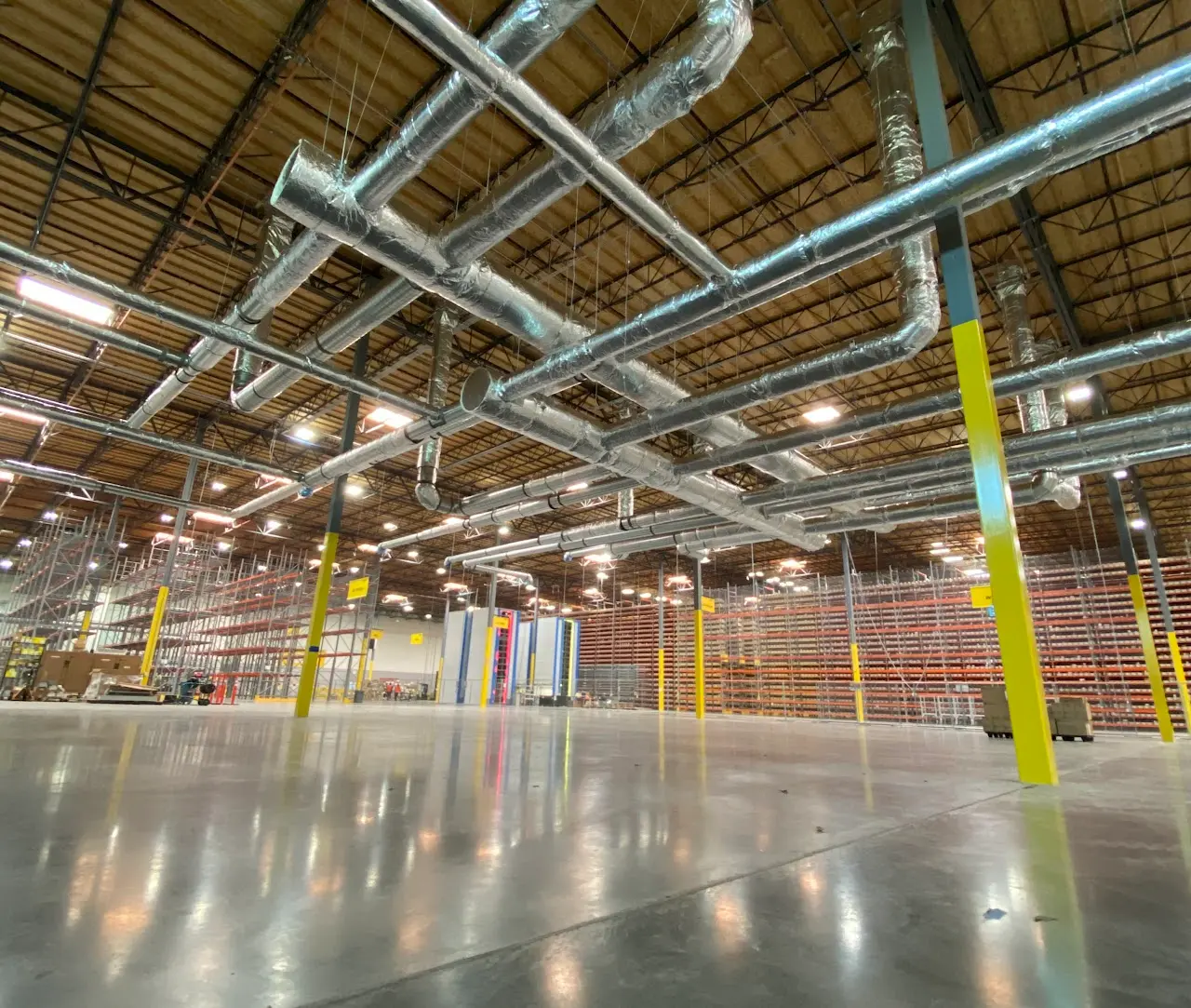 Spiral HVAC ductwork distribution across a Bay Area warehouse ceiling