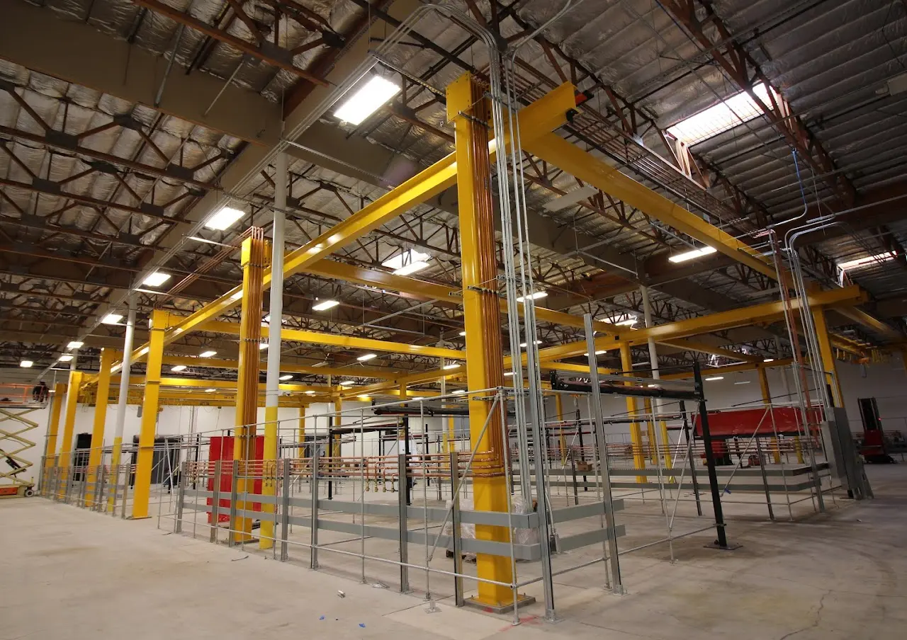 Structural steel framing and conduit during a Bay Area industrial warehouse mechanical install